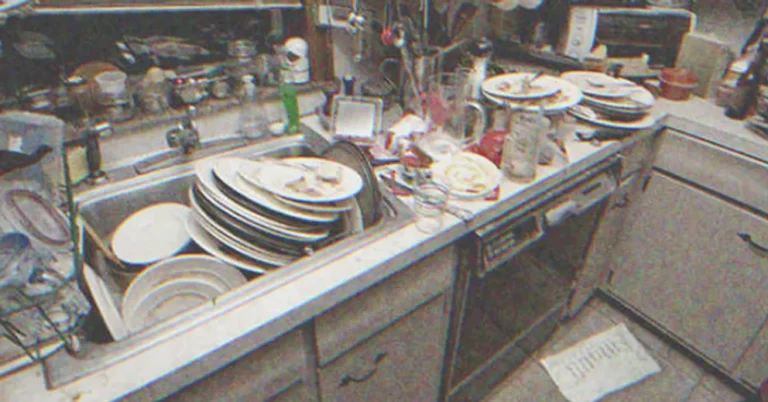 Sink overflowing with dirty dishes in the kitchen | Source: Shutterstock