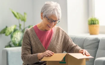 An old woman opening a box | Source: Shutterstock