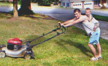 Man mowing lawn with a young boy on his back | Source: Shutterstock