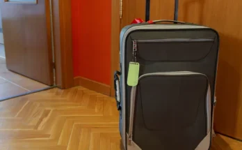 A suitcase placed outside an apartment front door | Source: Shutterstock