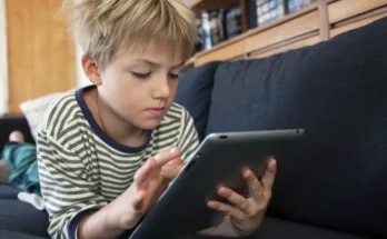 Boy engrossed in a tablet | Source: Shutterstock