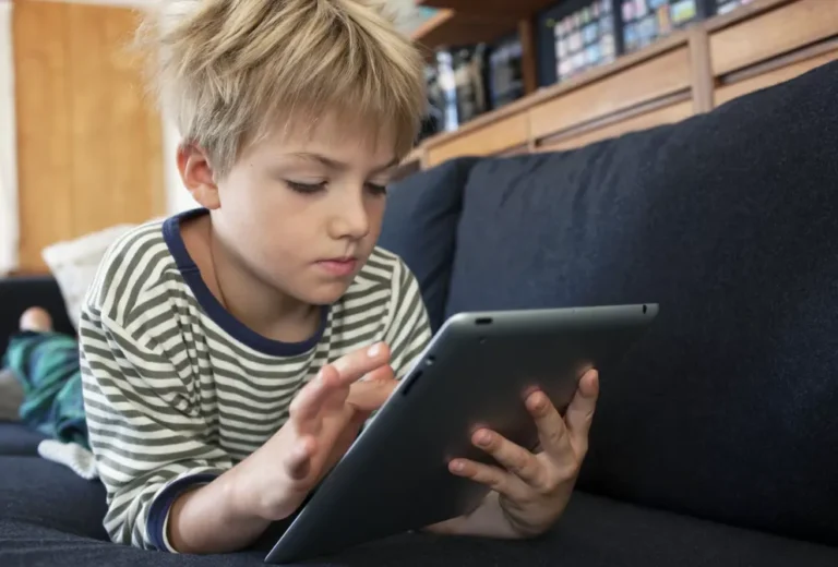 Boy engrossed in a tablet | Source: Shutterstock