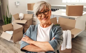 An elderly woman with boxes moving in | Source: Shutterstock