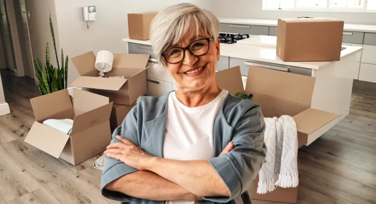 An elderly woman with boxes moving in | Source: Shutterstock