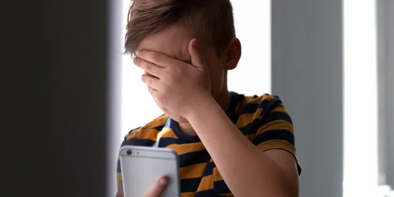 Boy crying while making a call | Source: Shutterstock