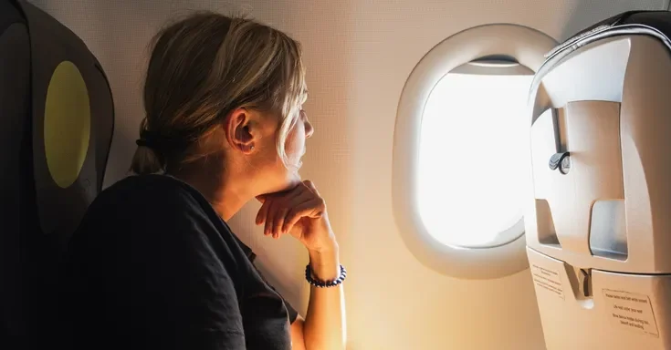 A woman sitting in an airplane | Source: Shutterstock