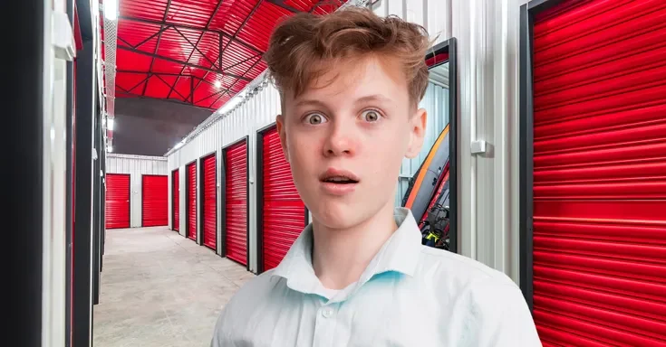 A shocked teenage boy in a storage room | Source: Shutterstock