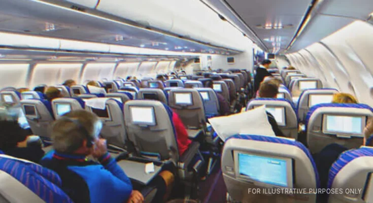 Passengers seated inside airplane | Source: Shutterstock