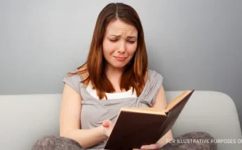 A woman reading a book and crying | Source: Shutterstock