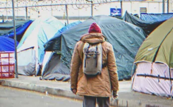 Man in front of tents. | Source: Shutterstock