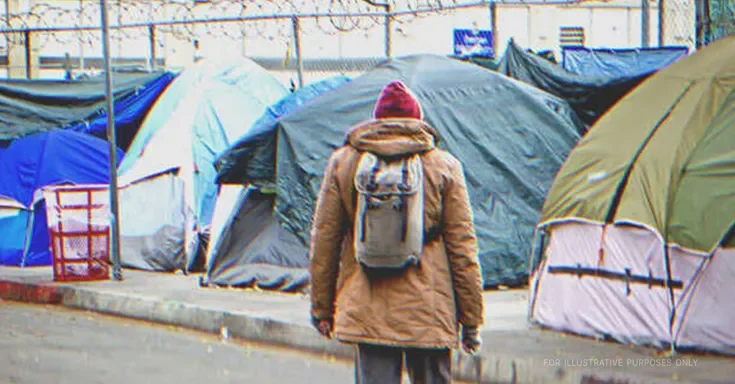 Man in front of tents. | Source: Shutterstock