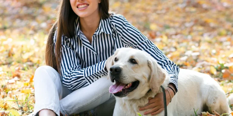 A woman with a Labrador dog | Source: Freepik.com