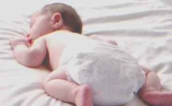 A baby laying on a bed | Source: Shutterstock