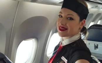 A flight attendant smiling | Source: Midjourney