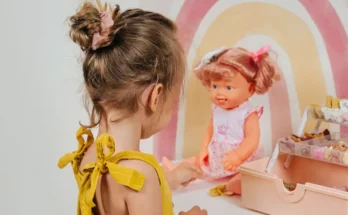 A girl playing with a doll | Source: Shutterstock