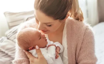 A woman holding her newborn baby | Source: Shutterstock