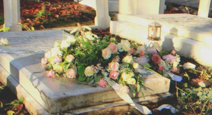 A grave covered in flowers | Source: Shutterstock