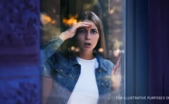 Woman looking at something through window | Source: Shutterstock