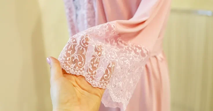 A woman touching pink fabric | Source: Shutterstock