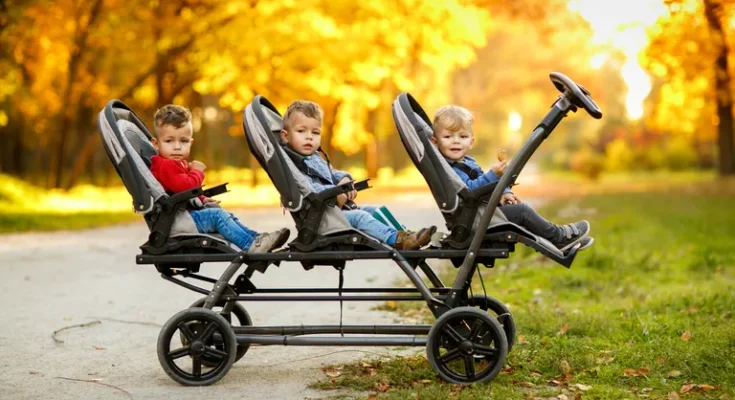 Cheerful triplets in a park. | Source: Shutterstock