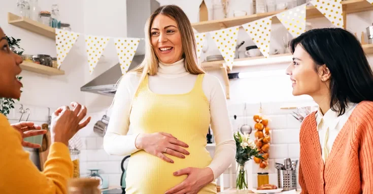 Pregnant woman bonding with her friends | Source: Getty Images