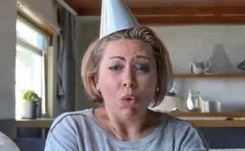 A shocked woman wearing a party hat | Source: Midjourney