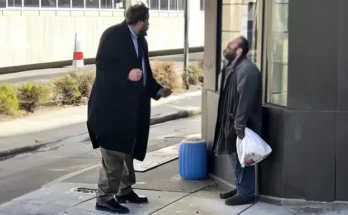 A man in a suit berating a homeless man | Source: Amomama