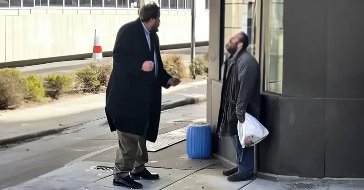 A man in a suit berating a homeless man | Source: Amomama