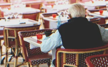 An old man sitting at a table | Source: Shutterstock