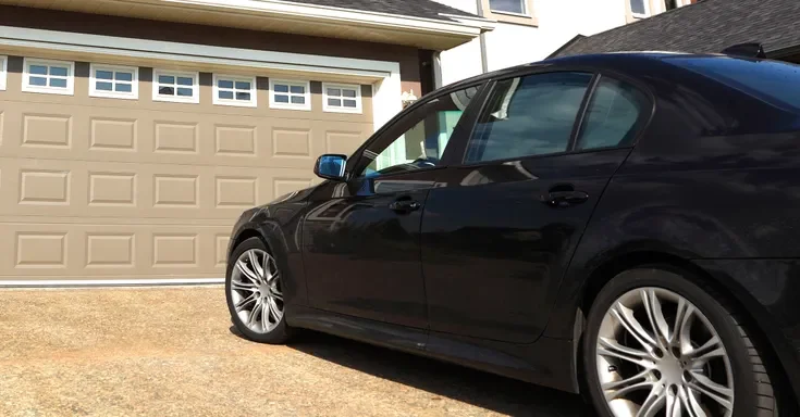 A car parked outside a garage | Source: Shutterstock