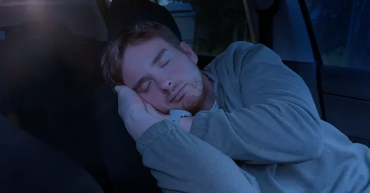 A man sleeping in his car | Source: Shutterstock