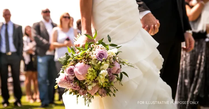 A bride and groom holding hands at their wedding | Source: Shutterstock