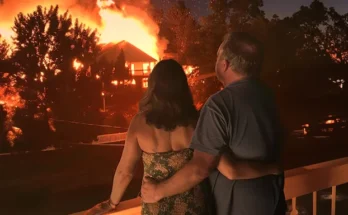 A couple watching a house on fire in their neighborhood | Source: Midjourney