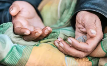 Coins in a homeless woman's hand | Source: Freepik