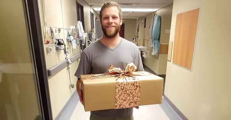 A man standing in a hospital holding a gift | Source: Amomama