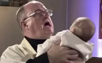 A shocked priest holding a baby | Source: Amomama