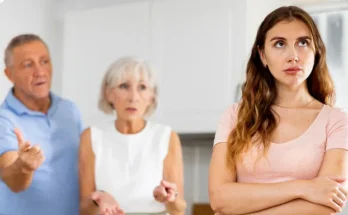 An elderly couple talking to their young daughter | Source: Shutterstock