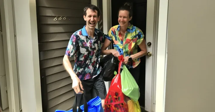 A couple standing at the door with plastic bags | Source: Amomama