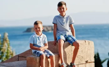 Two boys sitting outdoors | Source: Freepik