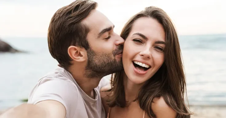 A smiling young couple | Source: Shutterstock