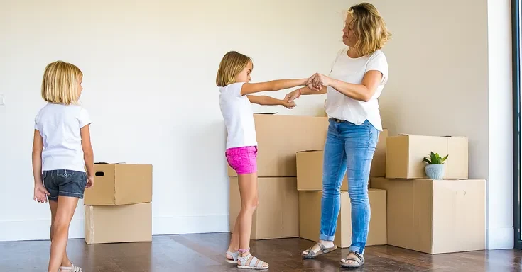 Mother and her children moving into a new home | Source: Shutterstock