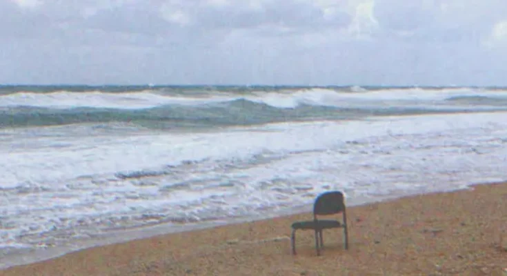 An empty chair on the beach | Source: Shutterstock