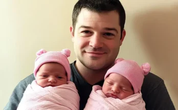 A man holding his twin daughters | Source: Amomama