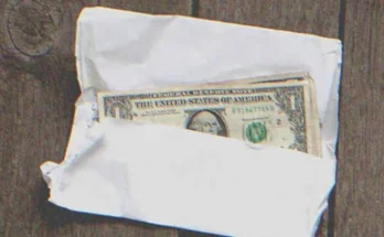 Several $1 bills in an envelope | Source: Shutterstock