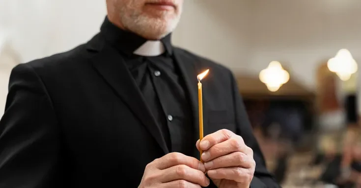 A priest holding a candle | Source: Freepik