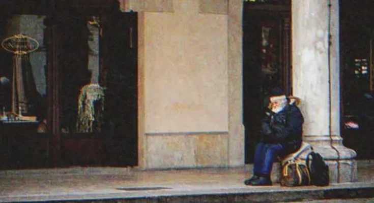 Old man sitting outside a building | Source: Shutterstock