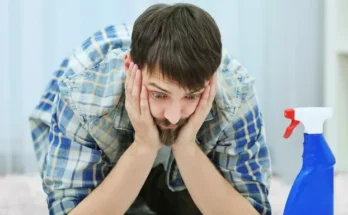 A confused man seeing a bottle of cleaner | Source: Shutterstock