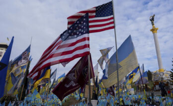 American and Ukrainian flags placed in honour of fallen servicemen flutter in the wind in front of statue in central square, in Kyiv, Ukraine, Tuesday, Nov. 5, 2024. (AP Photo/Alex Babenko)