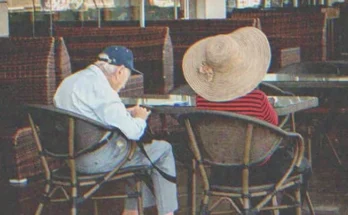 An old couple sitting at a table | Source: Shutterstock