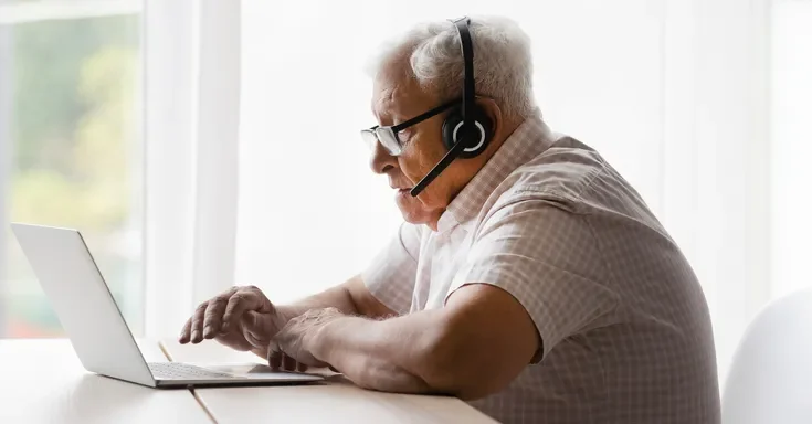 An older man using a laptop | Source: Shutterstock